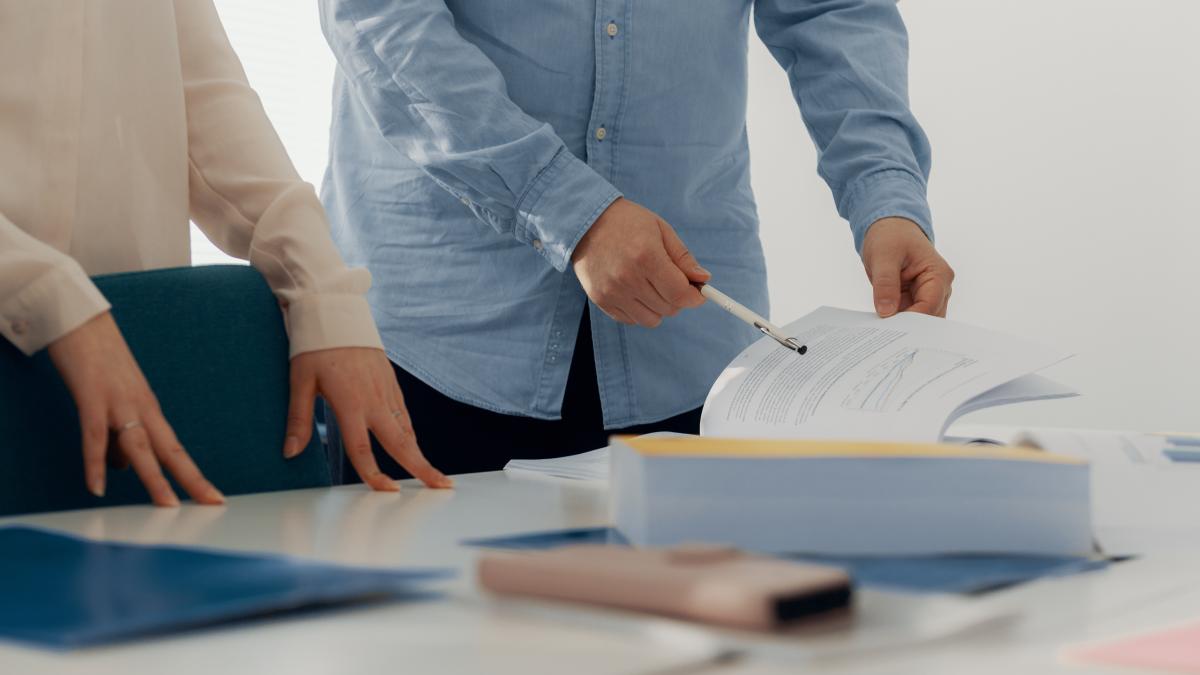 Henkilöitä tutkimassa budjettikirjaa