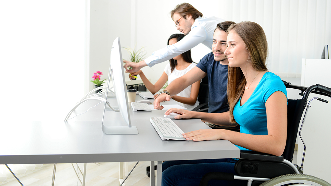 Woman in a wheelchair uses a computer